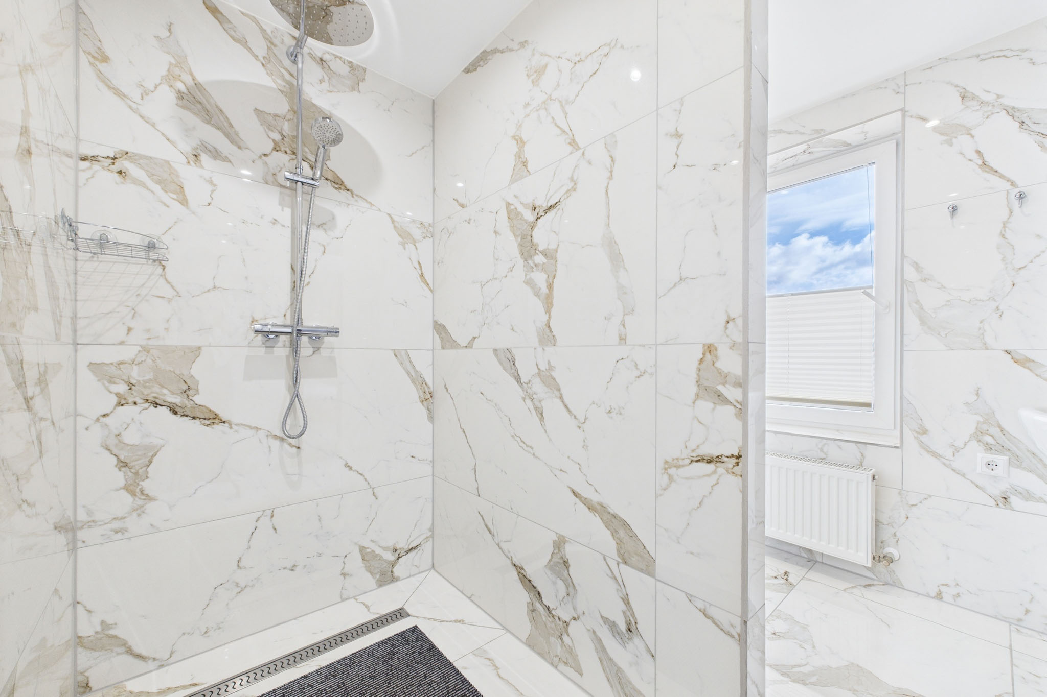 Ekskluzīvs dzīvokļa interjers: Duša ar liela formāta marmora flīzēm – nekustamā īpašuma fotogrāfijas